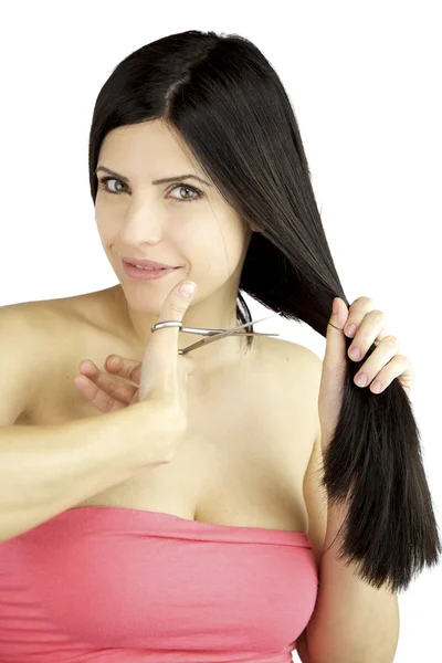 Beatiful female model cuts her long hair smiling — Stock Photo, Image