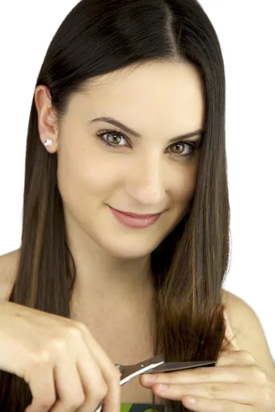 Young woman smiling cutting her split ends smiling — Stock Photo, Image