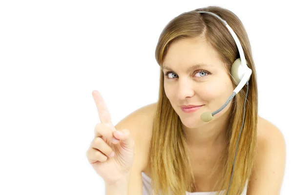 Attractive blond girl with headset shows your text — Stock Photo, Image