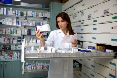 Pharmacist woman looking for medicine
