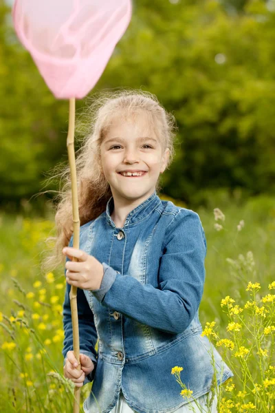 Girl with a net catching butterflies — Stock Photo, Image