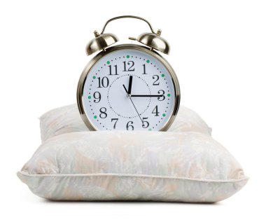 Metal alarm clock on a pillow clipart