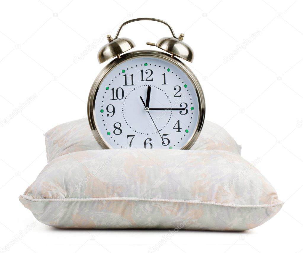 Metal alarm clock on a pillow