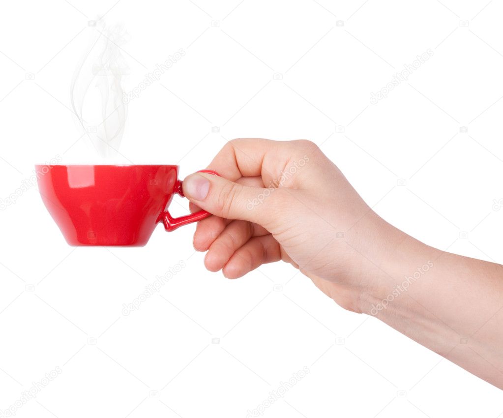Red cup of tea or coffee in hand