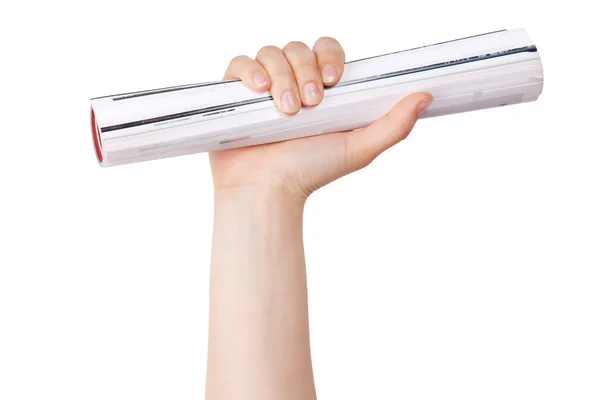 Lidská ruka drží válcované deník — Stock fotografie