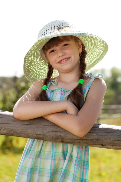 Menina de cabelos escuros em um chapéu de vime — Fotografia de Stock