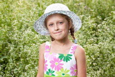 Charming blonde girl in the hat