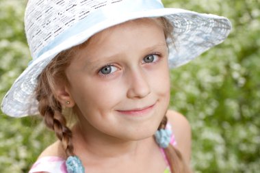 Charming blonde girl in a hat