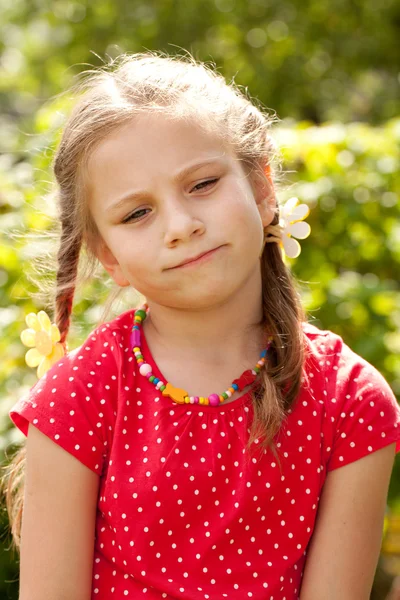 Sad little girl with pigtails — Stock Photo, Image