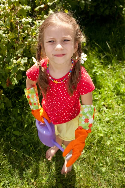 Little girl holding a garden watering can — Stock Photo, Image