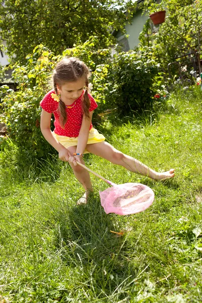 Girl with a pink butterfly net — Stock Photo, Image