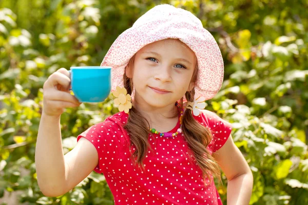Girl in the summer panama with a cup — Stock Photo, Image