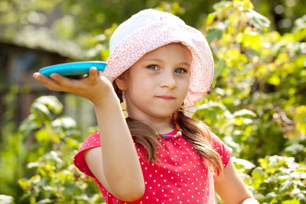 Little girl holding a toy plate — Stock Photo, Image