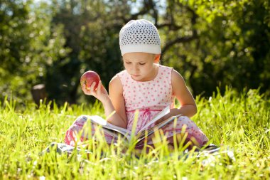 Pretty girl is reading a children's book clipart