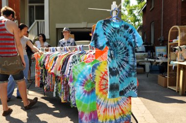 Tie-dye shirts at garage sale clipart