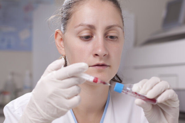 Injecting blood in test tube