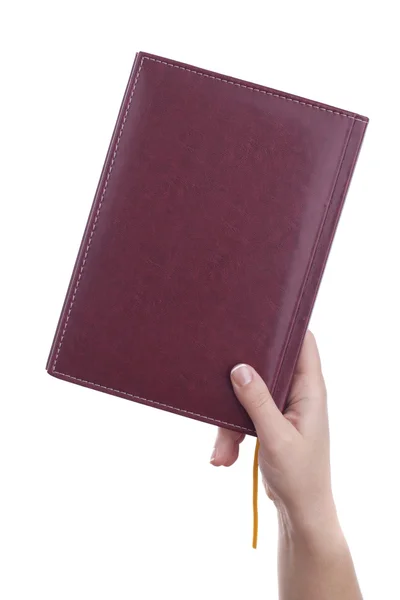Holding closed notebook — Stock Photo, Image