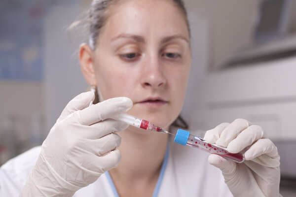 Injecting blood in test tube