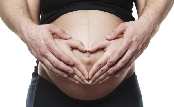 Hartvormige handen op zwangere vrouw buik — Stockfoto