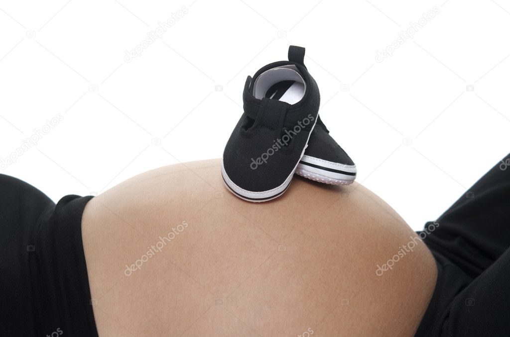 It's a boy, baby shoes on pregnant 