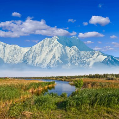 Majestic mountains beyond a prairies clipart