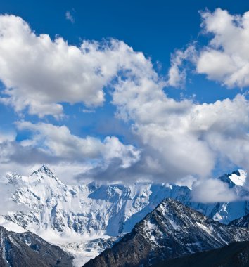 Majestic mountains in a clouds clipart