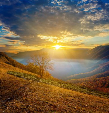 Sunrise above a mountain valley clipart