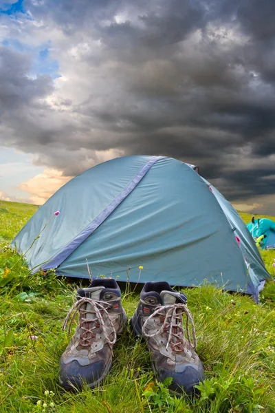 Touristic boots near a tent — Stock Photo, Image