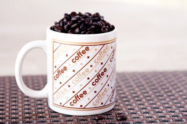 Fresh Coffee beans in a cup clipart