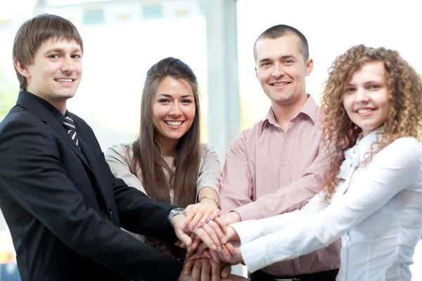 Closeup of business team putting their hands on top of each other — Stock Photo, Image