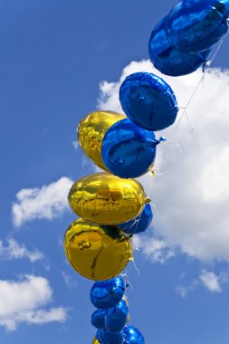 Balloons against the blue sky clipart