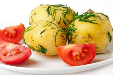 Young boiled potatoes with dill in oil and tomatoes clipart