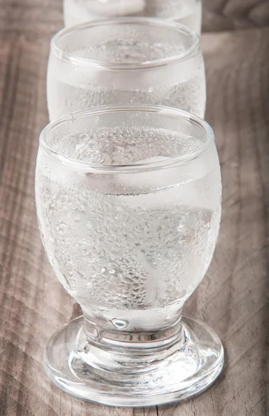 Glass of vodka on a wooden background — Stock Photo, Image