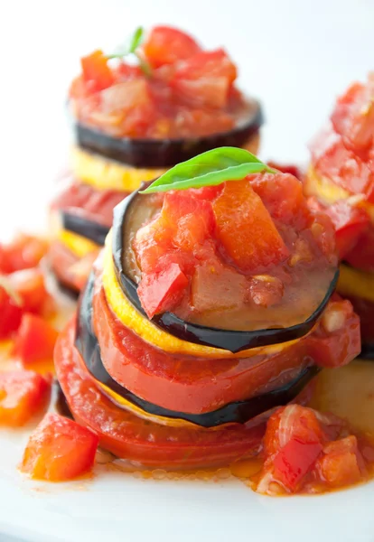 stock image Delicious Ratatouille on a white plate decorating with a leaf of basil