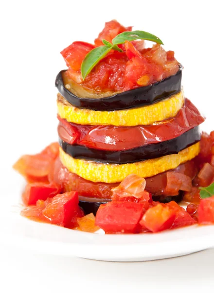 Delicious Ratatouille on a white plate decorating with a leaf of basil — Stock Photo, Image