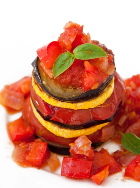 Delicious Ratatouille on a white plate decorating with a leaf of basil — Stock Photo, Image