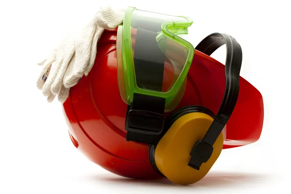 Červené bezpečnostní přilbu s sluchátka, brýle a rukavice — Stock fotografie