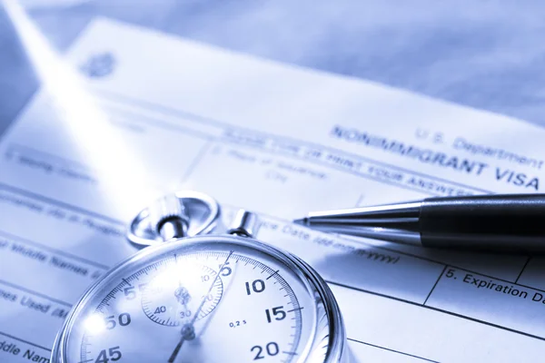 Application form with stopwatch and pen — Stock Photo, Image