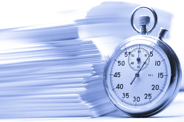 Pile of paper cards and stopwatch in blue — Stock Photo, Image