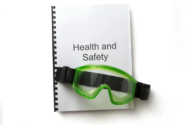 Регистр здоровья и безопасности с защитными очками — стоковое фото