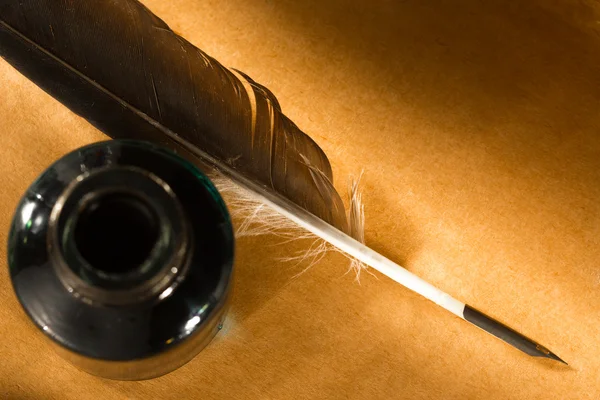 Feather ink bottle on paper — Stock Photo, Image