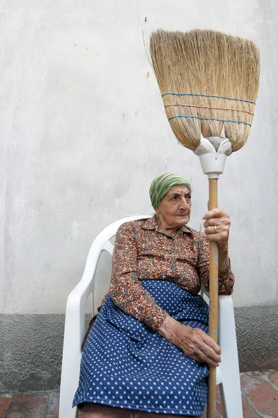 Senior woman broom — Stock Photo, Image