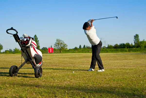 Playing golf on a driving range — Stock Photo, Image