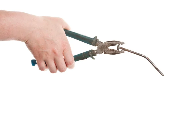 Female hand holding old pliers with nail — Stock Photo, Image