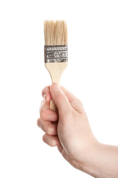 Mão com uma escova — Fotografia de Stock
