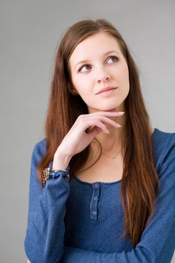 Pretty young student girl pondering. clipart