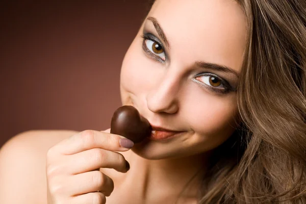 Chocolate loving brunette cutie. — Stock Photo, Image