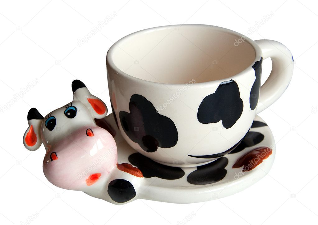 Cup and saucer in the form of a cow, isolated on white background