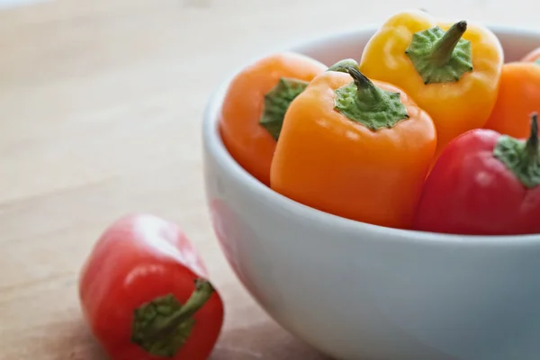 Colorful mini sweet peppers in a white bowl — Stock Photo, Image