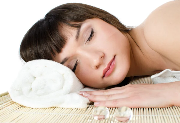 Mulher de cabelos escuros bonita relaxa em uma sala de massagem — Fotografia de Stock
